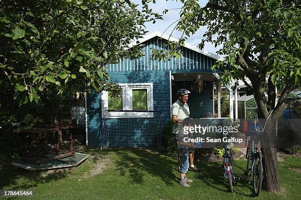 Father and son arrive at the garden and cottage they lease at the Oeynhausen Small Garden Association garden colony on August 29, 2013 in Berlin,...