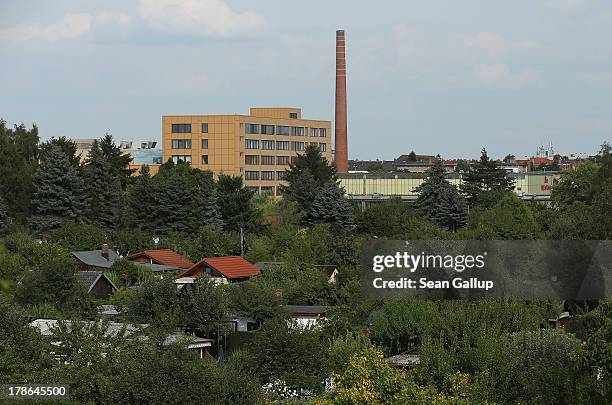 Cottages and gardens of the Oeynhausen Small Garden Association garden colony stand near a factory on August 29, 2013 in Berlin, Germany. At the...