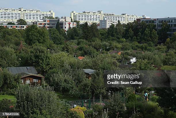 Cottages and gardens of the Oeynhausen Small Garden Association garden colony stand near apartment buildings on August 29, 2013 in Berlin, Germany....