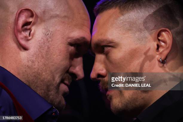 Britain's Tyson Fury and Ukraine's Oleksandr Usyk challenge each other during a press conference, in London, on November 16 ahead of their undisputed...