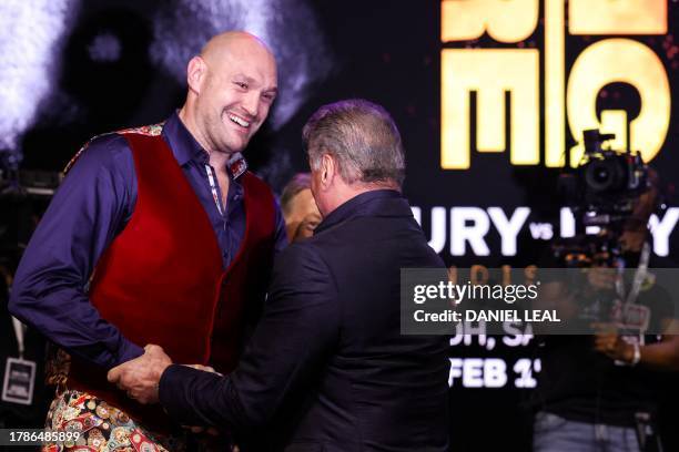 Britain's Tyson Fury speaks with US actor Sylvester Stallone during a press conference, in London, on November 16 ahead of his undisputed heavyweight...