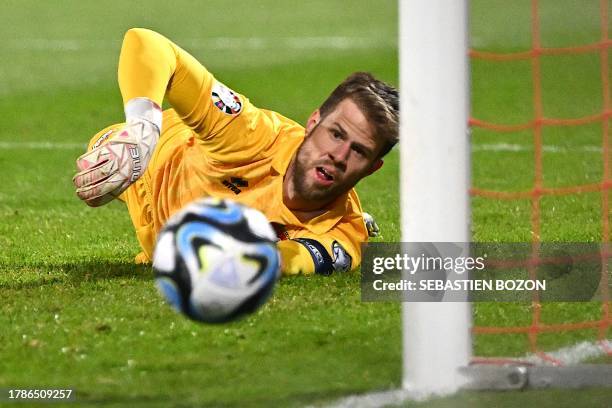 Liechtenstein's goalkeeper Benjamin Buchel deflects a shot during the UEFA Euro 2024 Group J qualification football match between Liechtenstein and...