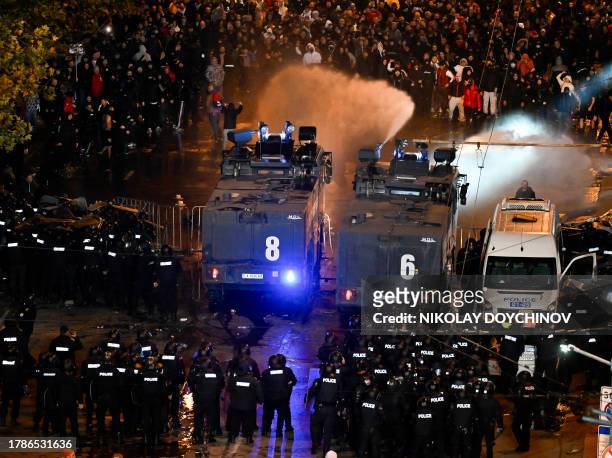 Police uses a water cannon towards protesters outside the Vassil Levski Stadium ahead of the UEFA Euro 2024 Group G qualification football match...