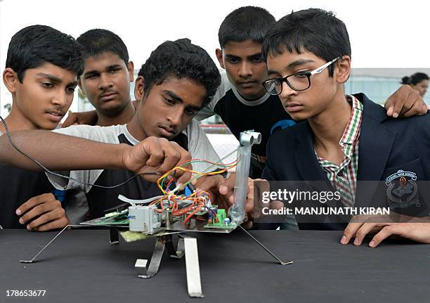 Indian schoolchildren give of demonstration of a six-legged spider-like robot on the inaugural day of the ten-day Edinburgh International Science...
