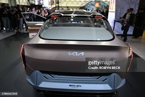 Visitors look at the Kia Concept EV4 during the Kia press conference at Automobility LA, the media preview day for the LA Auto Show, on November 16,...