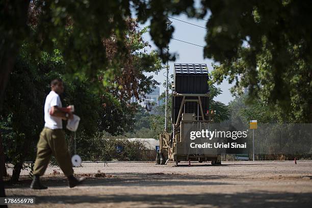 An Israeli soldier walks past the 'Iron Dome' missile defense system on August 30, 2013 in Tel Aviv, Israel. Tensions are rising in Israel amid...