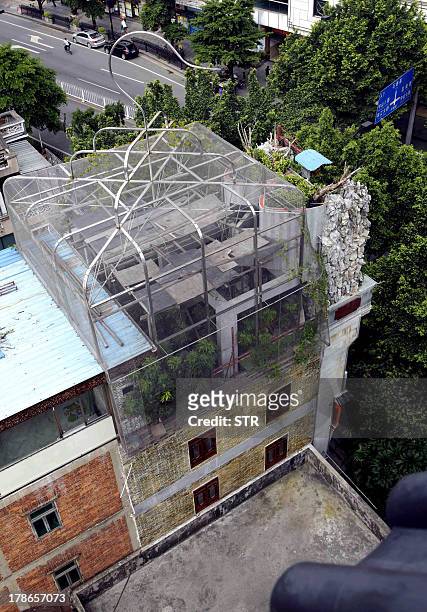 General view of a giant steel and mesh "birdcage" that caps the uppermost level of a building in Guangzhou, southern China's Guangdong province on...
