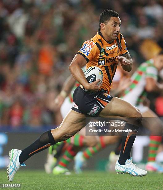 Benji Marshall of the Tigers runs with the ball during the round 25 NRL match between the Wests Tigers and the South Sydney Rabbitohs at Allianz...