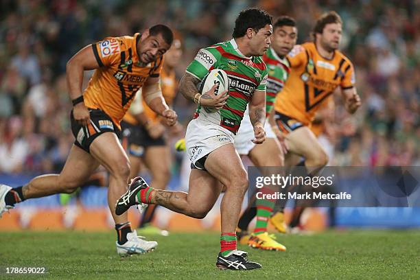 Issac Luke of the Rabbitohs makes a break during the round 25 NRL match between the Wests Tigers and the South Sydney Rabbitohs at Allianz Stadium on...