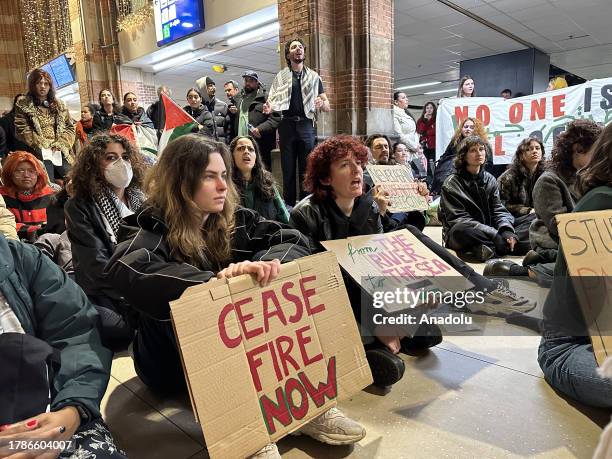 People take part in a sit-in protest to call for ceasefire in Gaza under Israel's ongoing attacks, at Amsterdam Centraal Station in the Netherlands...