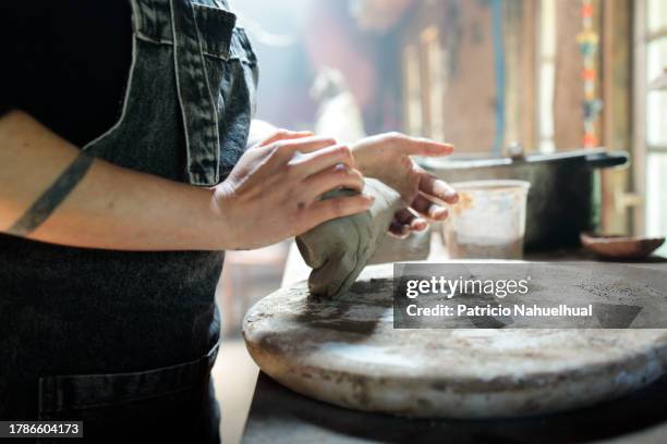 candid portrait showcasing an unrecognizable young latina artisan skillfully kneading clay for mapuche sculpture, a candid insight into her creative world - hands kneading stock pictures, royalty-free photos & images