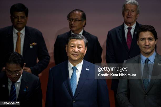 Chinese President Xi Jinping and Canadian Prime Minister Justin Trudeau stand with other world leaders for a "family photo" during the Asia-Pacific...