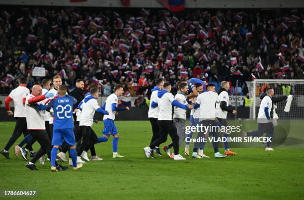 Slovakia's team celebrates after the Euro 2024 football tournament group J first round qualifying match between Slovakia and Iceland in Bratislava,...