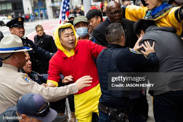 Police and private security try to break up skirmishes between anti-Chinese Communist Party protesters and pro-China protesters near the Asia-Pacific...