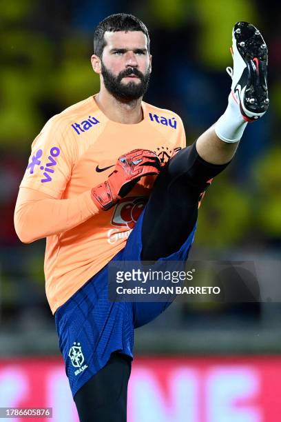 Brazil's goalkeeper Alisson warms up before the start of the 2026 FIFA World Cup South American qualification football match between Colombia and...
