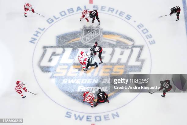 Claude Giroux of the Ottawa Senators and Dylan Larkin of the Detroit Red Wings get set to take a face-off during the 2023 NHL Global Series in Sweden...