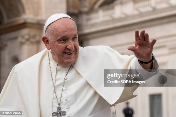 Pope Francis waves as he leaves St. Peter's Square after leading his traditional Wednesday General Audience.