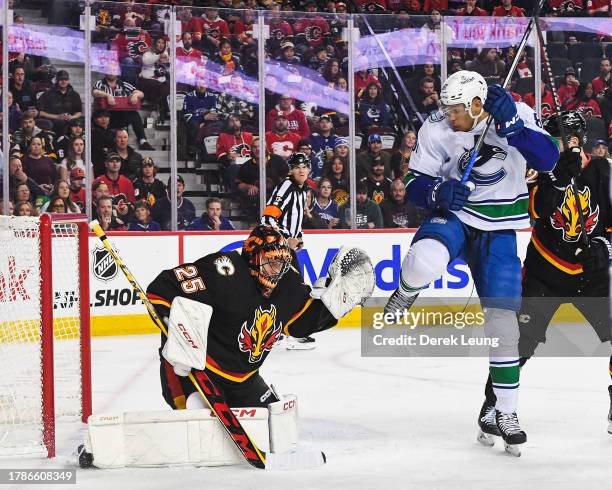 Jacob Markstrom of the Calgary Flames stops a shot from Dakota Joshua of the Vancouver Canucks during the first period of an NHL game at Scotiabank...