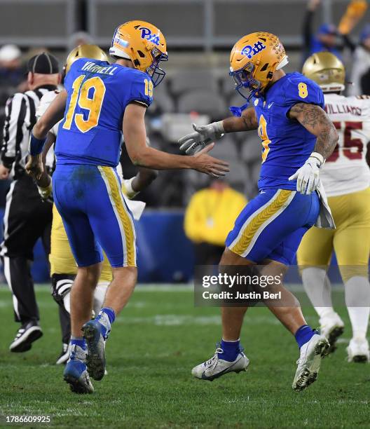 Nate Yarnell of the Pittsburgh Panthers celebrates with Karter Johnson after throwing a 61-yard touchdown pass to Bub Means in the second half during...