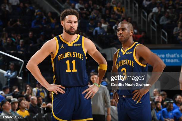 Klay Thompson and Chris Paul of the Golden State Warriors look on during the game against the Oklahoma City Thunder on November 16, 2023 at Chase...