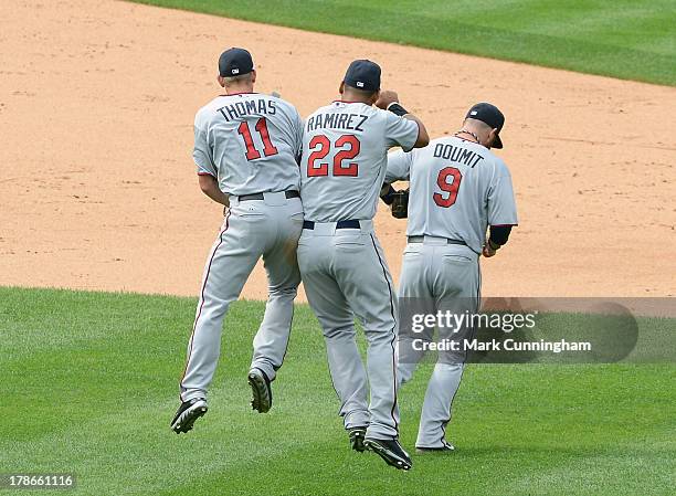 Clete Thomas, Wilkin Ramirez and Ryan Doumit of the Minnesota Twins celebrate the victory against the Detroit Tigers at Comerica Park on August 22,...