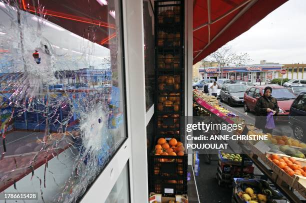 The windows of a halal butcher shop pockmarked by some 23 kalachnikov's bullets fired by gunmen in the early hours on April 25, is pictured on April...