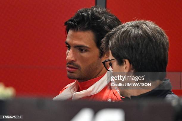 Ferrari's Spanish driver Carlos Sainz Jr. Checks out his car in the garage ahead of the second practice session for the Las Vegas Grand Prix on...