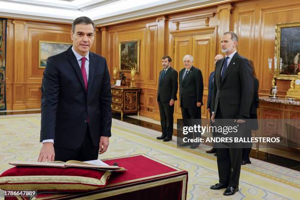 Spain's Prime Minister Pedro Sanchez takes part with Spain's King Felipe VI in a ceremony to swear oath on the constitution, a day after being...