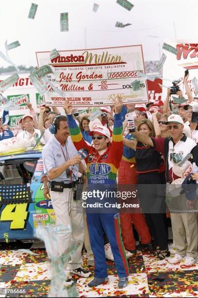 Jeff Gordon celebrates with a giant Winston Million check after winning the Mountain Dew Southern 500 at Darlington Raceway in Darlington, South...