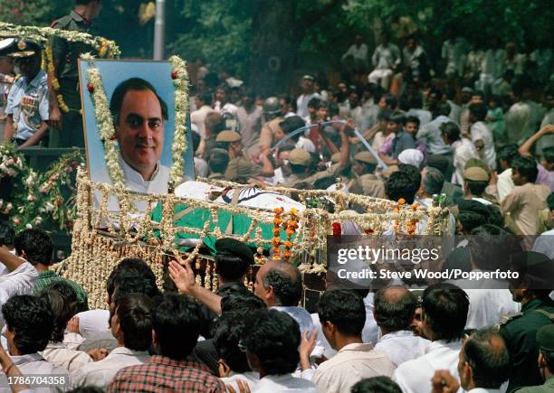 The body of Indian Prime Minister Rajiv Gandhi , is carried through crowds along the streets during his funeral procession, on 24th May in New Delhi,...
