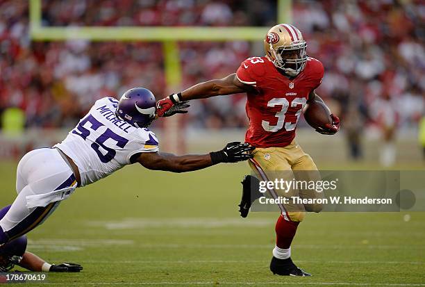 Jewel Hampton of the San Francisco 49ers carries the ball running away from Marvin Mitchell of the Minnesota Viking in the third quarter at...