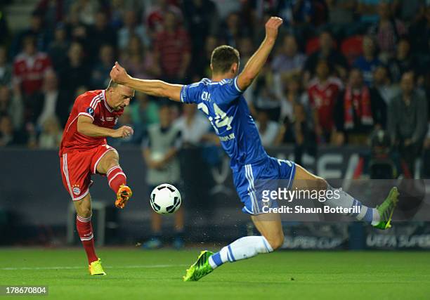 Gary Cahill of Chelsea goes in to block a shot from Franck Ribery of Bayern Munich during the UEFA Super Cup between Bayern Muenchen and Chelsea at...