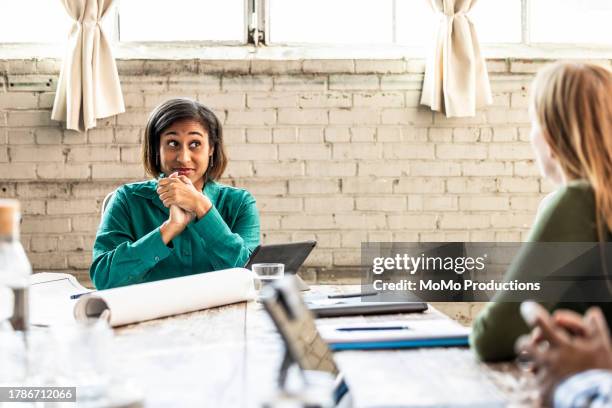 colleagues having discussion in modern conference room - raised eyebrows stock pictures, royalty-free photos & images