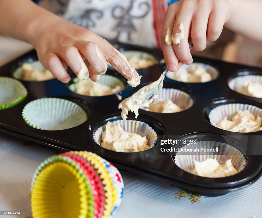 Messy hands baking fairy cakes