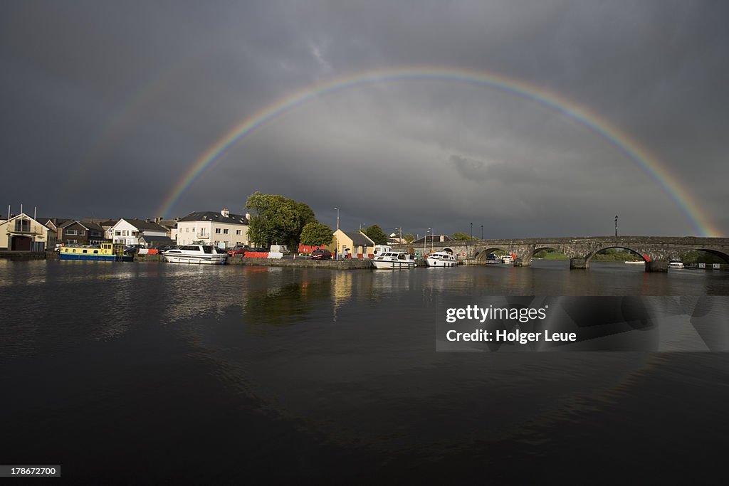Rainbow above bridge over Shannon river
