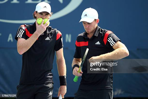 Jamie Murrary of Great Britain talks tactics with his partner John Peers of Australia during their men's doubles second round match against Feliciano...