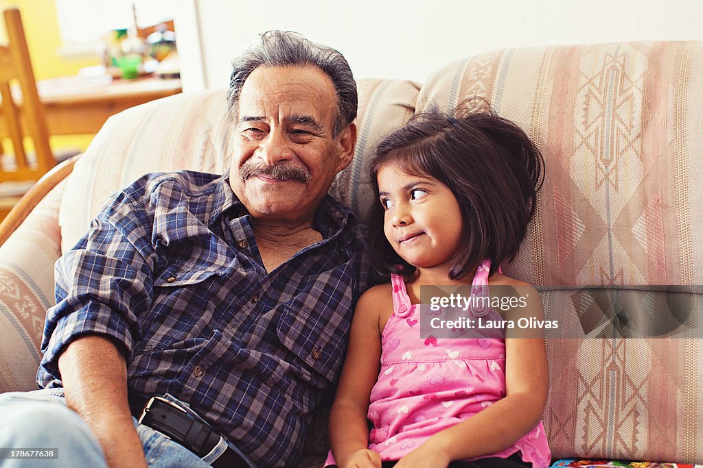 Grandfather and Granddaughter Laughing on Couch