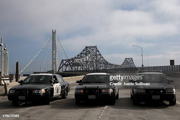 California Highway Patrol officers block access to the deck of the old eastern span of the San Francisco Oakland Bay Bridge that stands next to the...