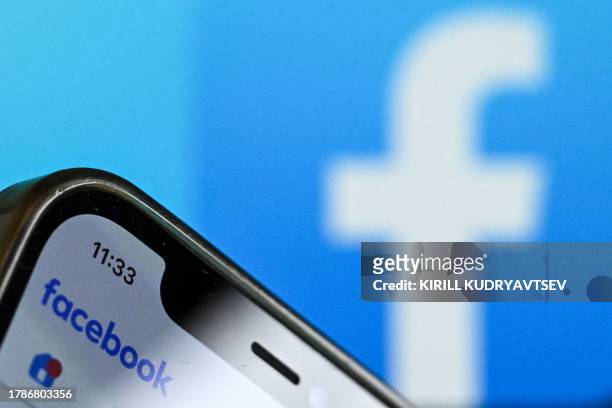 Photo taken on November 17, 2023 shows the logo of US online social media and social networking service Facebook on a smartphone screen in Frankfurt...