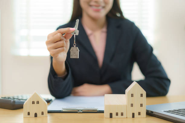 real estate agent handing key to client - house with key stock pictures, royalty-free photos & images