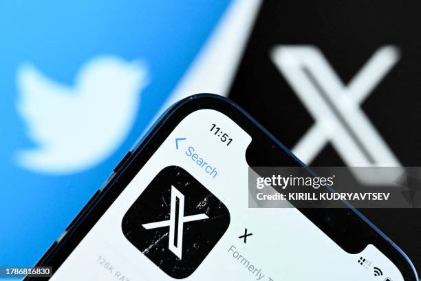 Photo taken on November 17, 2023 shows the logo of US online social media and social networking service X - formerly Twitter - on a smartphone screen...