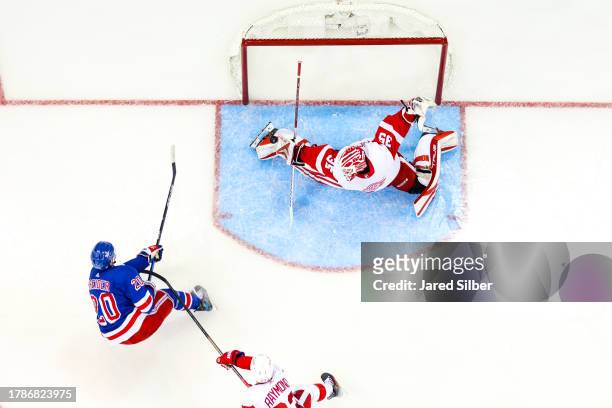 Ville Husso of the Detroit Red Wings makes a save against Chris Kreider of the New York Rangers at Madison Square Garden on November 7, 2023 in New...