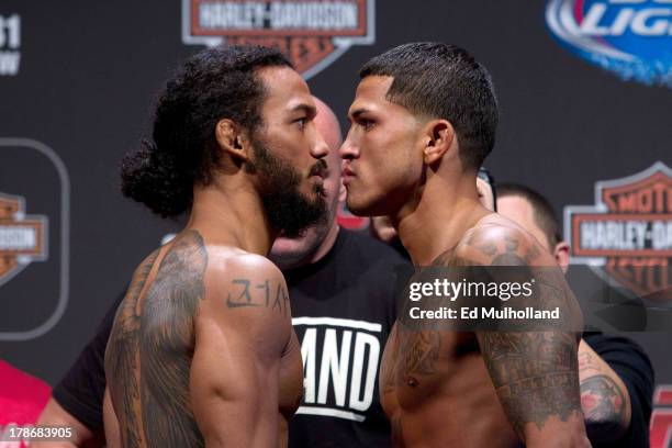 Benson Henderson squares off against Anthony Pettis during the UFC 164 weigh-in inside the BMO Harris Bradley Center on August 30, 2013 in Milwaukee,...