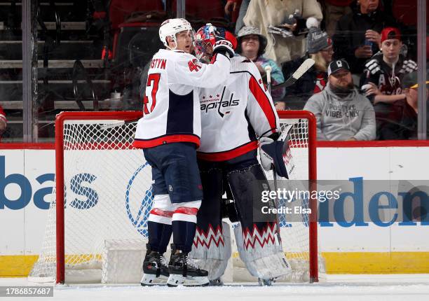 Beck Malenstyn and Charlie Lindgren of the Washington Capitals celebrate the win over the New Jersey Devils during the third period at Prudential...