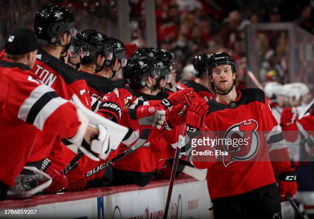 Dawson Mercer of the New Jersey Devils is congratulated by teammates on the bench after he scored during the third period against the Washington...