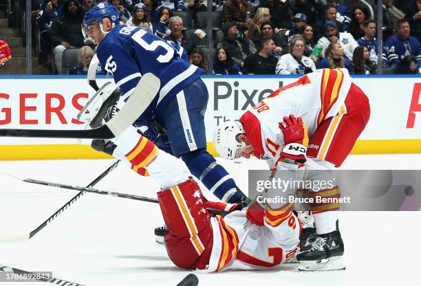 Martin Pospisil of the Calgary Flames celebrates his third period goal against the Toronto Maple Leafs and is joined by Mikael Backlund at Scotiabank...