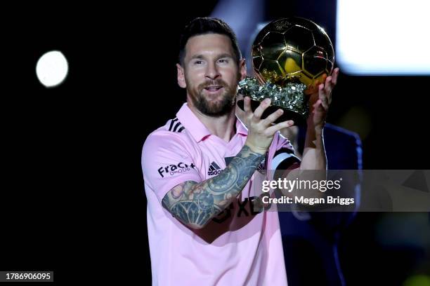 Lionel Messi of Inter Miami CF hoist his trophy during the Ballon d'Or trophy presentation at DRV PNK Stadium on November 10, 2023 in Fort...