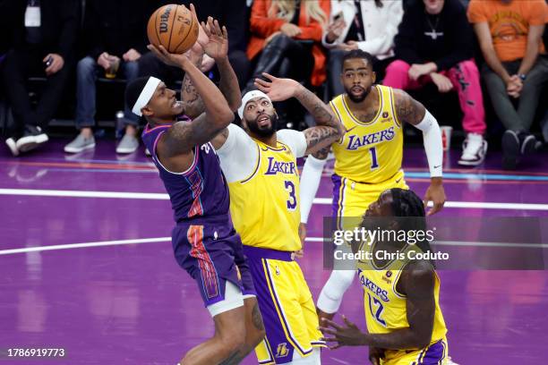 Bradley Beal of the Phoenix Suns attempts a shot over Anthony Davis of the Los Angeles Lakers and Taurean Prince during the first half of the NBA...
