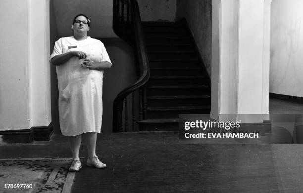 Tour guide dressed as a nurse stands in the first-floor lobby in the main building of the Trans-Allegheny Lunatic Asylum in Weston, West Virginia on...