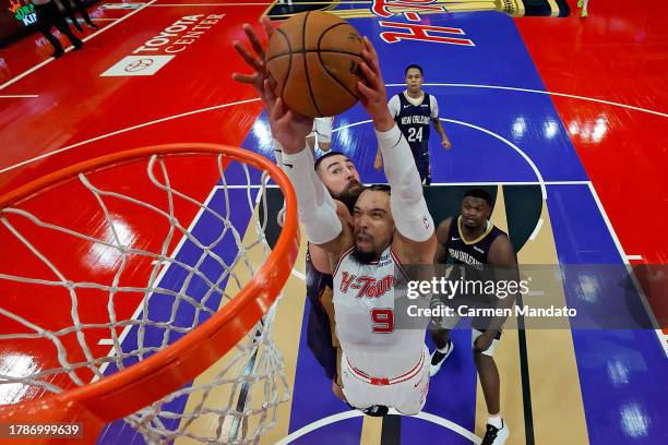 Dillon Brooks of the Houston Rockets attempts to dunk the ball ahead of defender Jonas Valanciunas of the New Orleans Pelicans during the second half...